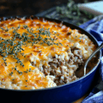 Plate of ground beef and rice casserole garnished with fresh parsley
