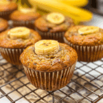 Moist banana muffins with chocolate chips on a cooling rack